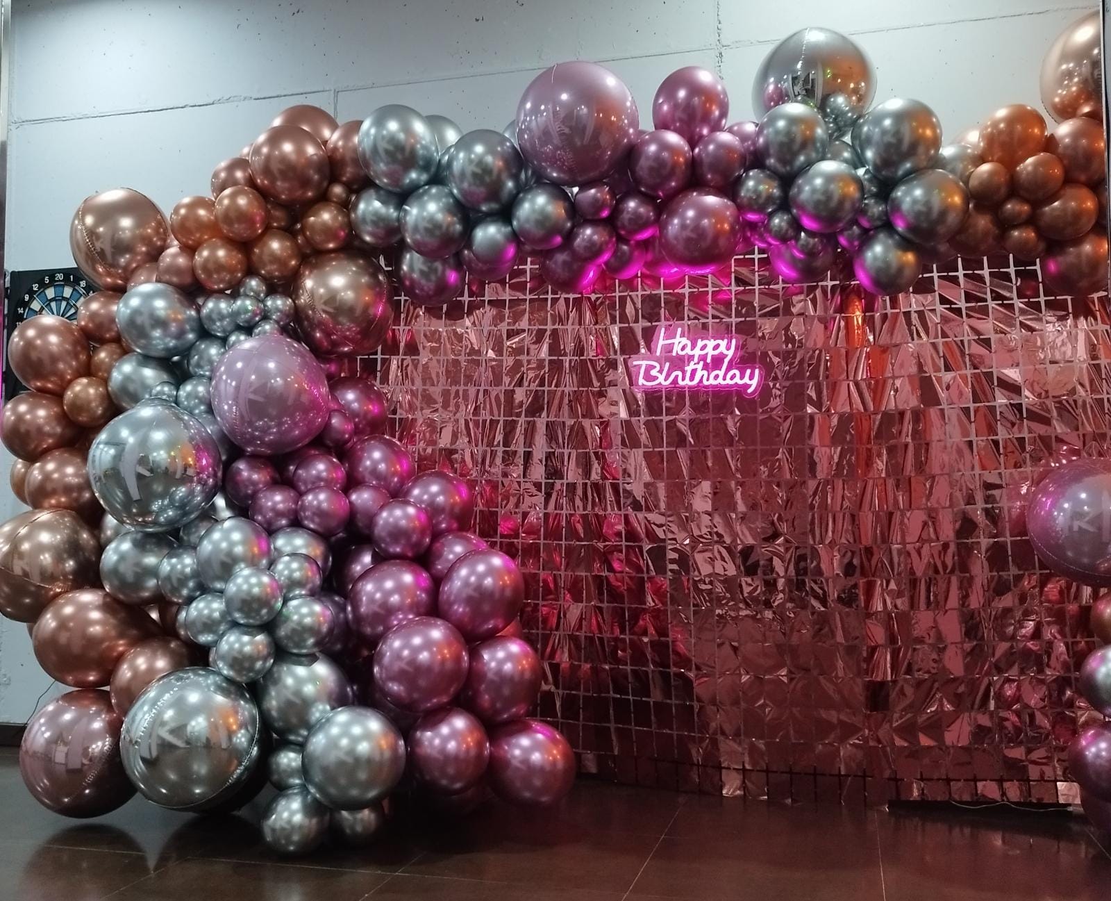 Photocall lleno de brillo y diversión con globos rosa y plata y con feliz cumpleaños en luces de neón